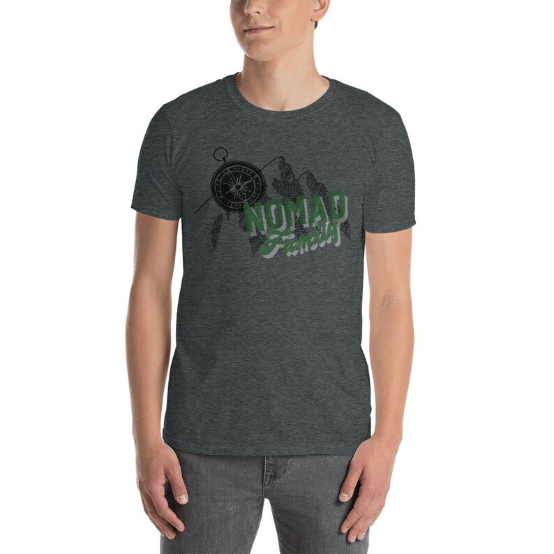 May include: A dark heather grey t-shirt with a compass, mountains, and the text "NOMAD  Famously" in green and black.