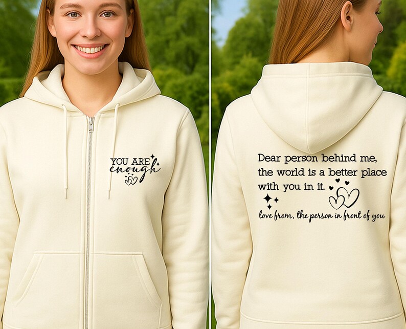 May include: Cream-colored zip-up hoodie with the text "YOU ARE enough" on the front. The back of the hoodie features the message "Dear person behind me, the world is a better place with you in it. love from, the person in front of you."