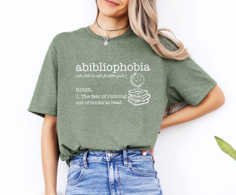 May include: Green t-shirt with the word "abibliophobia" defined as "the fear of running out of books to read".