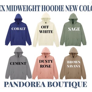 a collection of six midweight hoodies in various colors, including cobalt blue, off white, sage green, cement gray, dusty rose pink, and brown savana brown. The hoodies are arranged in a grid, showcasing the different color options available at the pandorea boutique.