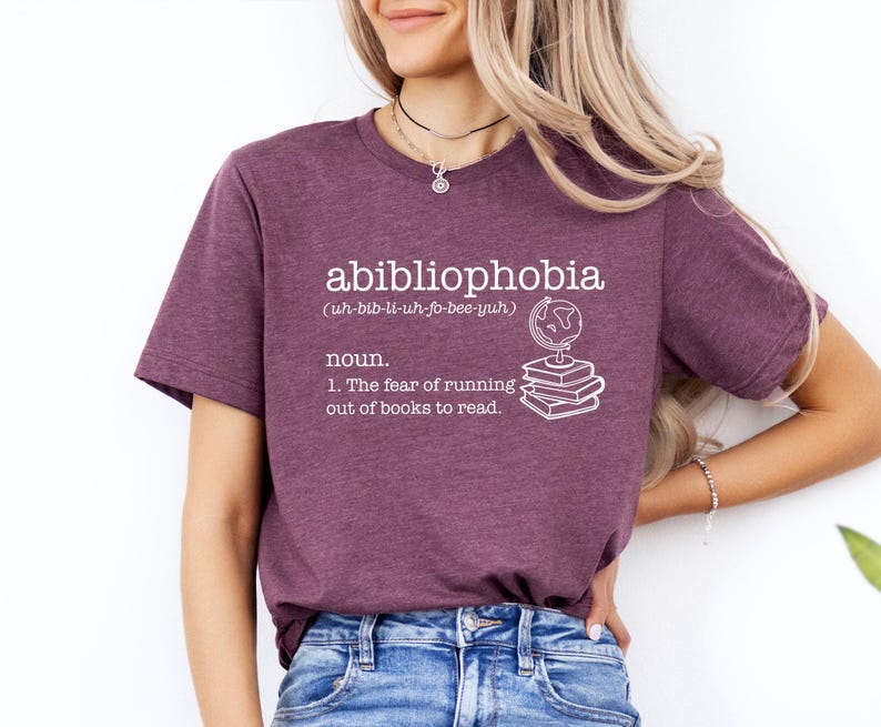 May include: A purple t-shirt with the word "abibliophobia" defined as "the fear of running out of books to read". The definition is accompanied by an illustration of a globe and a stack of books.