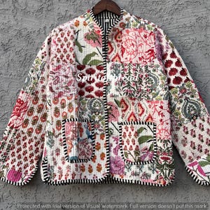 May include: A quilted jacket with a patchwork design featuring floral and paisley patterns in shades of red, pink, green, and white. The jacket has two pockets and a black and white striped trim. The text "Spiritead" is visible.