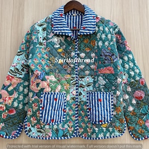 May include: A quilted jacket featuring a teal base with a multi-colored floral and botanical print. The garment includes a blue and white striped collar, cuffs, and two front pockets, with the text Spiritofthread printed on the front.