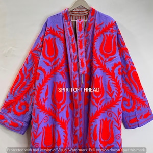 May include: A purple jacket with vibrant red floral embroidery. The jacket features a long, open design with a matching embroidered tie closure. The text "SPIRITOFTHREAD" is visible. The jacket is hanging on a wooden hanger.