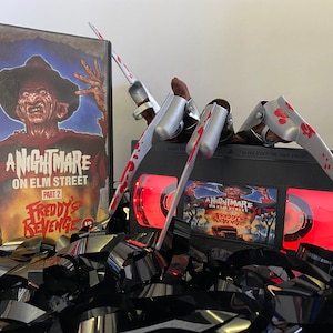 Deluxe Nightmare on Elm Street 2: Freddy&#39;s Revenge VHS Horror Lamp with added Freddy Glove and blood, a great gift for film buffs