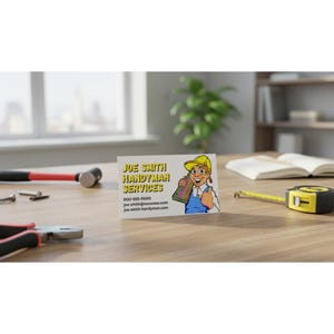 May include: Business card for Joe Smith Handyman Services. The card features a cartoon handyman holding a piece of wood and giving a thumbs up. A hammer, pliers, screws, and a tape measure are on the wooden surface.