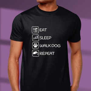 May include: Black t-shirt with white text that reads "Eat, Sleep, Walk Dog, Repeat".