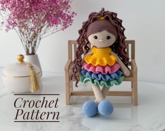 May include: Crochet pattern for a doll with brown hair, a yellow, pink, blue and green dress, and blue shoes. The doll is sitting on a wooden bench. The text "Crochet Pattern" is written below the doll.