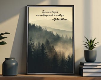 May include: Framed art print featuring a misty mountain landscape with dark green trees. The print has a black frame and includes the quote, "The mountains are calling and I must go - John Muir" in black text.