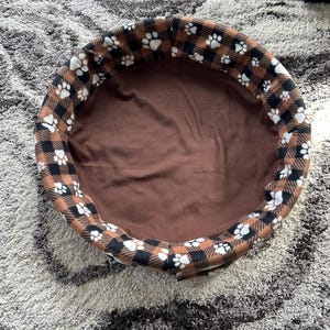 May include: A rustic wooden sign with the text "Welcome to our home" in white lettering. The sign features a distressed finish and a simple, inviting design, perfect for entryway decor.