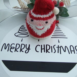 This is a Digital Knitting Pattern of a Father Christmas Chocolate Orange Cover