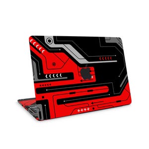 May include: A laptop featuring a red, black, and grey circuit board design. The design incorporates arrows, lines, and an Apple logo. The laptop is open, showcasing the design on the lid and keyboard area.
