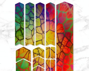 May include: A set of colorful bike frame protection stickers with a geometric pattern. The stickers are in shades of red, orange, yellow, green, and blue.