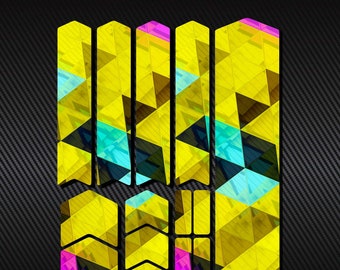 May include: A set of yellow, pink, and blue geometric patterned stickers for a skateboard. The stickers are shaped like arrows and rectangles.
