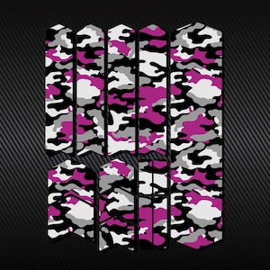 May include: Pink, black and grey camouflage bike frame protection kit. The kit includes multiple pieces to cover the frame of a bike.