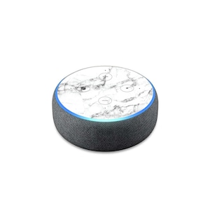May include: A white marble patterned skin for an Amazon Echo Dot smart speaker. The speaker is black with a blue light ring around the top.
