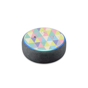 May include: A black and gray Amazon Echo Dot smart speaker with a colorful geometric pattern skin. The skin features a variety of pastel colors, including pink, blue, yellow, and green.