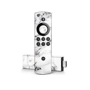 May include: A remote control and streaming device with a white marble design. The remote has a circular navigation pad and various control buttons. The streaming device is rectangular with a USB port. The devices are white with black and gray veining.