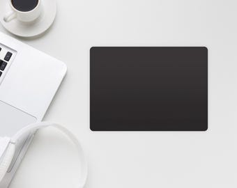 May include: A white laptop computer with a black keyboard, a white coffee cup with black coffee, a white saucer, and a pair of white headphones on a white surface. A black rectangle is in the centre of the image.