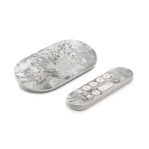 May include: A streaming device and remote control with a marble design. The devices are primarily white with a gray and gold marble pattern. The remote has several buttons, including a circular directional pad.