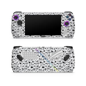 May include: A white handheld gaming console with a black and white skull and lightning bolt pattern. The console has a black screen and purple buttons.