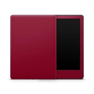 Op de afbeelding: Een bordeauxrode e-reader met een zwart scherm en een witte achtergrond.