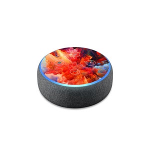 May include: A black smart speaker with a colorful abstract design on the top. The speaker has a blue light ring around the top edge.