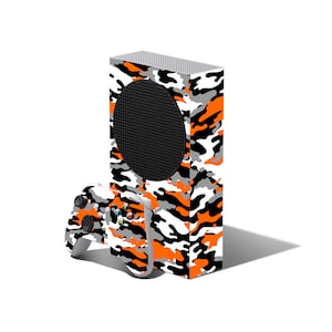 May include: A white and orange camouflage Xbox Series X console with a matching controller.