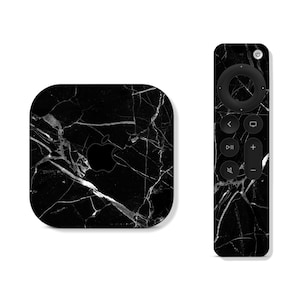 May include: Black Apple TV 4K with a white marble design. The matching remote control also features a white marble design.