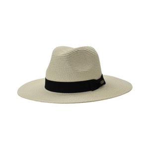 May include: A beige straw fedora with a black ribbon and a small gold buckle. The hat has a wide brim and a slightly indented crown.
