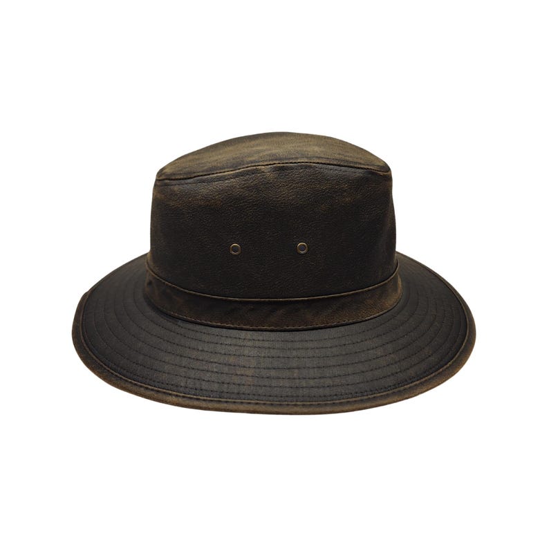 May include: A dark brown leather hat with a wide brim and a slightly distressed appearance. The hat features a rounded crown with two small eyelets and a band around the base of the crown. The brim has a textured, ridged design.