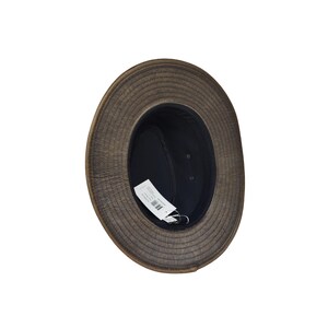 May include: A brown hat with a wide brim and a dark interior. The hat has a textured appearance and a tag attached inside. The hat's brim is approximately 3 inches wide. The hat is designed to provide sun protection.