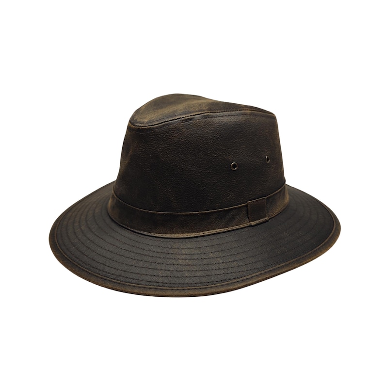 May include: A dark brown leather hat with a wide brim and a slightly indented crown. The hat features a band around the base of the crown and two small eyelets on the side. The leather has a distressed, weathered appearance.