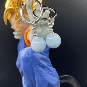 May include: Silver hoop earrings with a light blue gemstone dangling from each hoop.