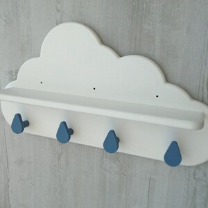 May include: White cloud shaped shelf with four blue raindrop shaped hooks.