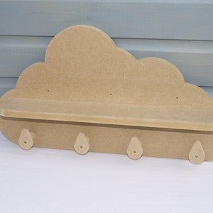 May include: A wooden cloud-shaped shelf with a small shelf and four hooks. The shelf is unfinished and ready to be painted or stained.