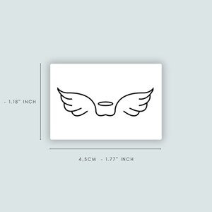 Op de afbeelding: Een zwarte lijntekening van engelenvleugels met een halo op een witte achtergrond. De afbeelding meet 4,5 cm bij 3 cm.