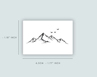 May include: A black and white line drawing of a mountain range with three birds flying above. The image is 1.77 inches wide and 1.18 inches tall.