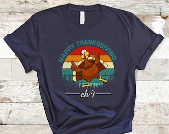 May include: A dark blue t-shirt featuring a vintage-style graphic of a turkey with the text "Happy Thanksgiving - eh?"