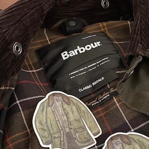 May include: A brown corduroy jacket with a black Barbour label and a green quilted lining. The label reads "Barbour. J. Barbour & Sons Ltd, Simonside, South Shields. Made in England. Fabrique en Angleterre. Classic Bedale. Original Barbour Tard. Original Authentic."