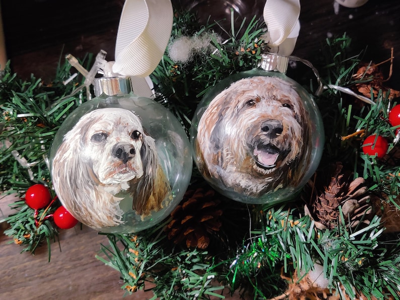 Custom painted pet glass ornament. Hand painted detailed realistic pet portrait on transparent round glass bauble ornament. 2 ornament shown dogs.