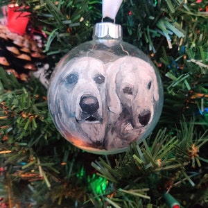 Custom painted double pet glass ornament. 2 hand painted detailed realistic pet portraits on a transparent round glass bauble ornament.