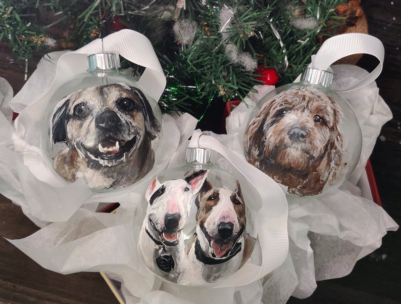 Custom painted pet glass ornament. Hand painted detailed realistic pet portrait on transparent round glass bauble ornament. 3 ornament shown, dog.