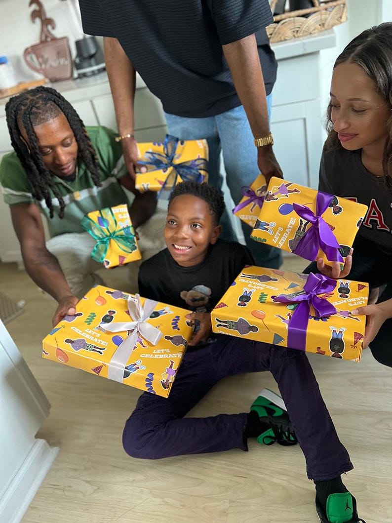 May include: A group of people holding wrapped gifts. The gifts are wrapped in yellow paper with a repeating pattern of figures and the text "LET'S CELEBRATE!". Each gift is tied with a colorful ribbon.