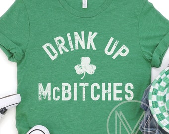 May include: Green t-shirt with a white distressed graphic that says "Drink Up McBitches" with a shamrock in the middle.