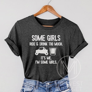 May include: Gray t-shirt with white text that reads "Some girls ride & drink too much. It's me. I'm some girls."  The shirt also features a white silhouette of an ATV and a shot glass.