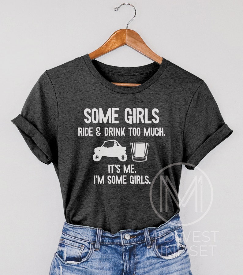 May include: Gray t-shirt with white text that reads "Some girls ride & drink too much. It's me. I'm some girls."  The shirt also features a white silhouette of an ATV and a shot glass.