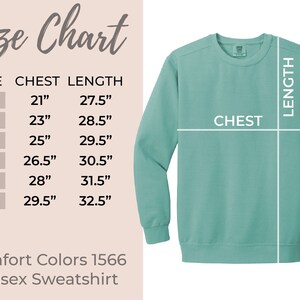 May include: Size chart for a unisex sweatshirt in various sizes, showing chest and length measurements in inches. The chart shows sizes S, M, L, XL, 2XL, and 3XL. The sweatshirt is a light teal color.