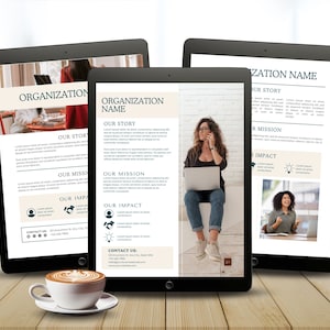 May include: Three black tablets displaying a business presentation with the text "ORGANIZATION NAME", "OUR STORY", "OUR MISSION", and "OUR IMPACT". A cup of coffee sits in front of the tablets on a wooden surface.