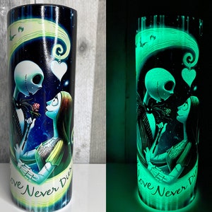 May include: A black and green glow-in-the-dark tumbler with a graphic of Jack Skellington and Sally from the Nightmare Before Christmas. The tumbler has the text "Love Never Dies" on it.